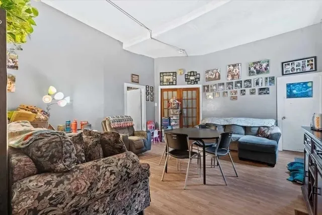 a living room with furniture a lamp and a potted plant