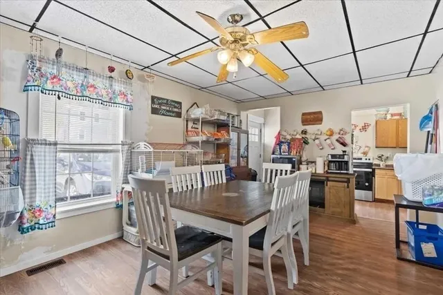 a view of a dining room with furniture window and wooden floor