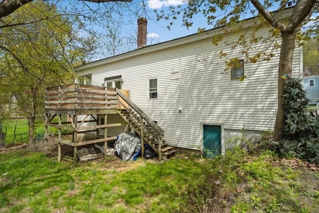 83 West Main Street Orange, MA 01364 - Photo 8 of 12 a view of a backyard with plants and a large tree