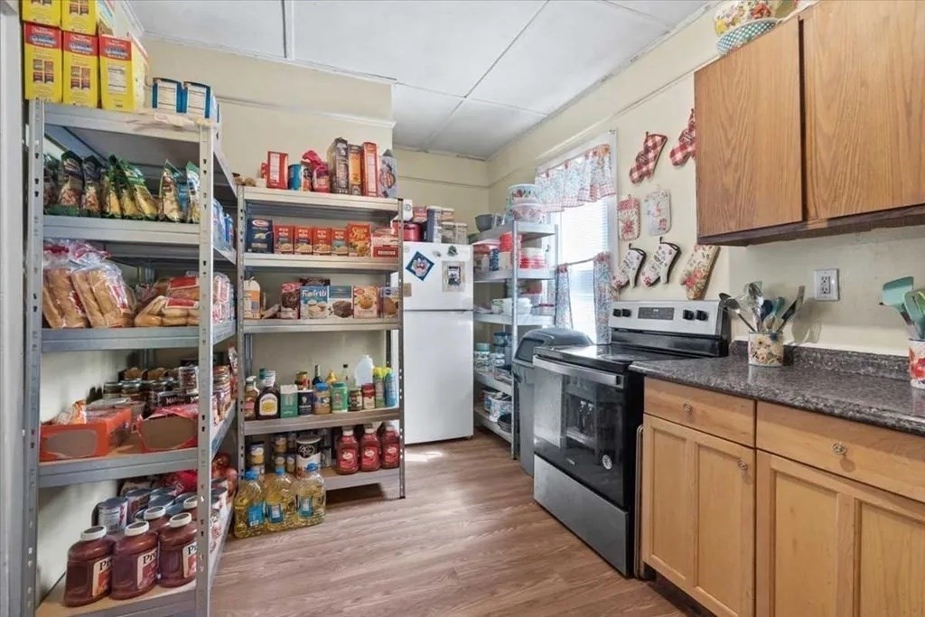 83 West Main Street Orange, MA 01364 - Photo 9 of 12 a kitchen with stainless steel appliances granite countertop a lot of counter top space and cabinets