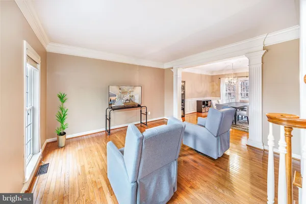 a kitchen with stainless steel appliances wooden floor and a refrigerator