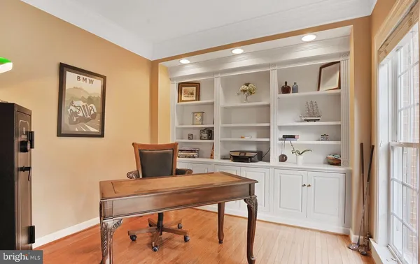 a kitchen with stainless steel appliances granite countertop a table chairs sink and cabinets