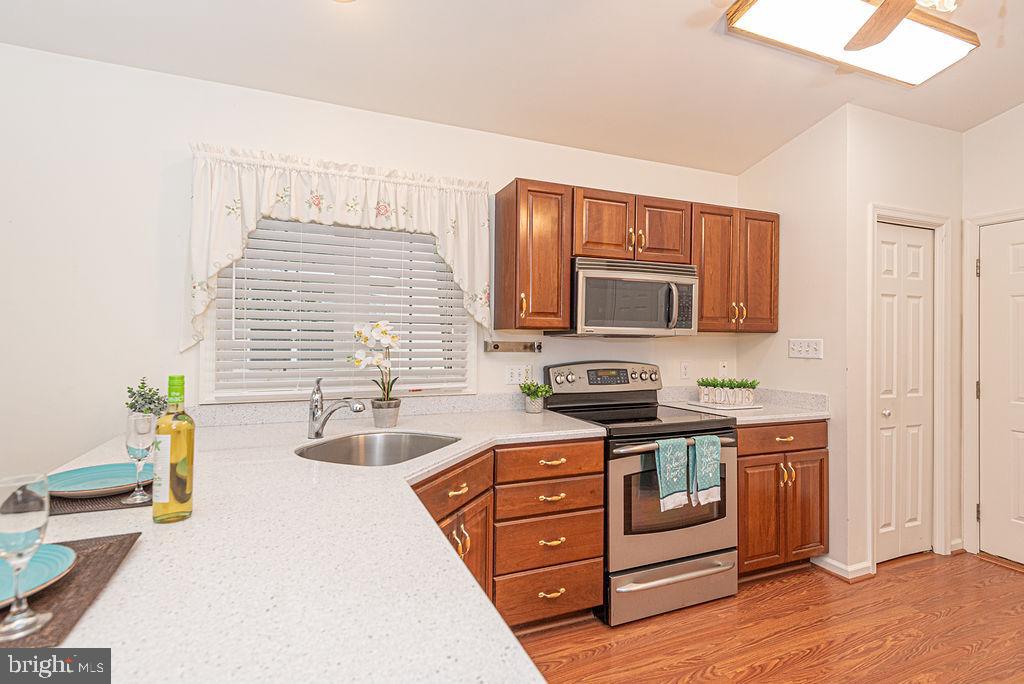 14 Liberty Street Ocean Pines, MD 21811 - Photo 17 of 69 a kitchen with stainless steel appliances granite countertop a stove a sink and a microwave