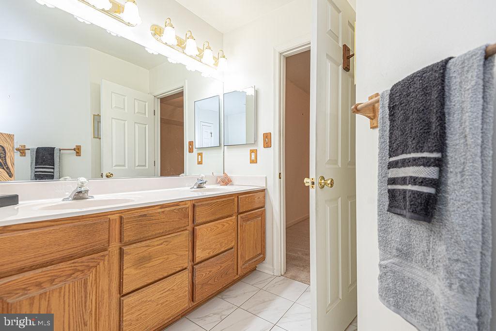 14 Liberty Street Ocean Pines, MD 21811 - Photo 38 of 69 a spacious bathroom with a double vanity sink a mirror and shower