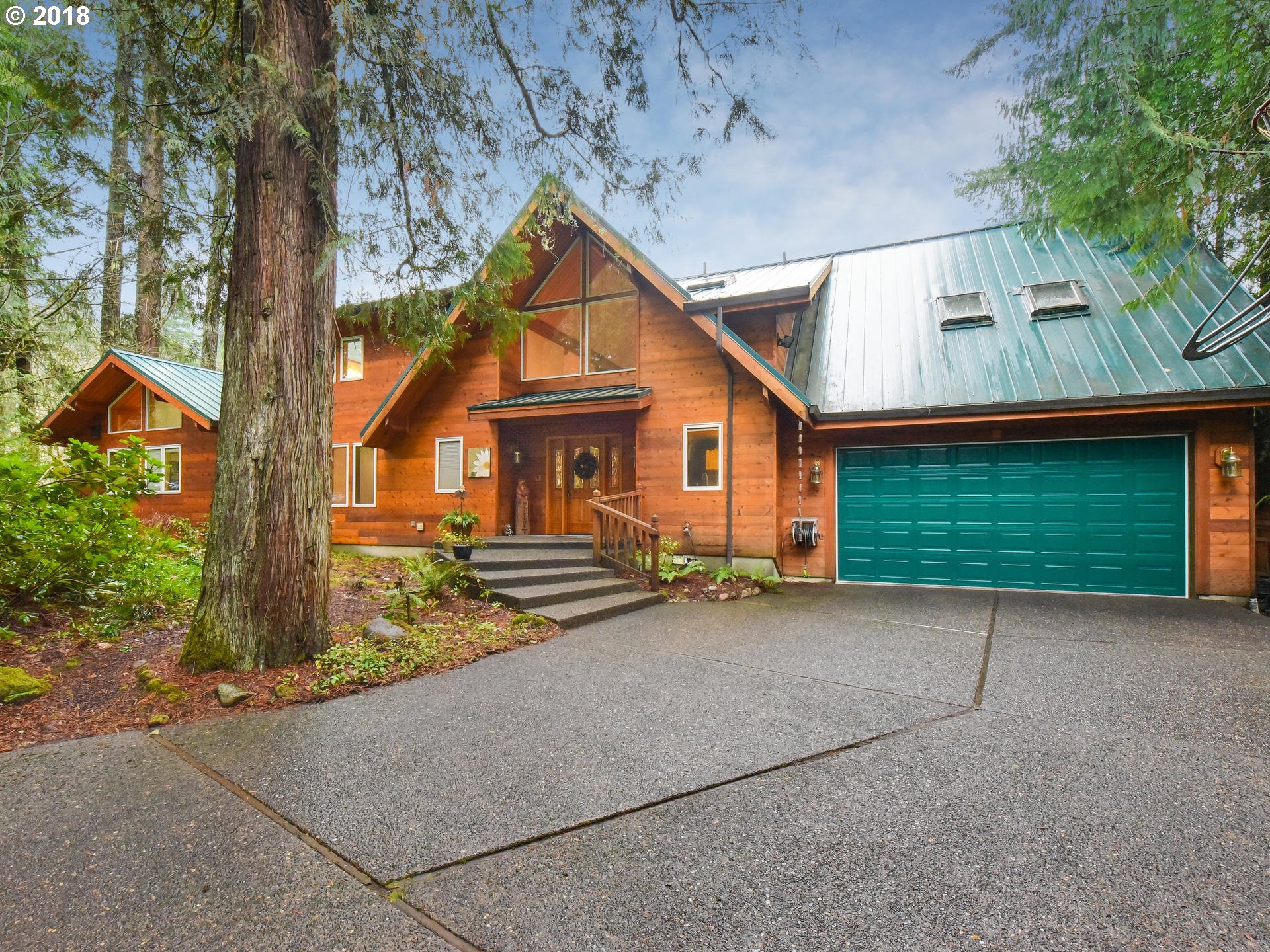 22200 East Lolo Pass Road Rhododendron, OR 97049 - Photo 1 of 32 a view of a house with a yard and large tree