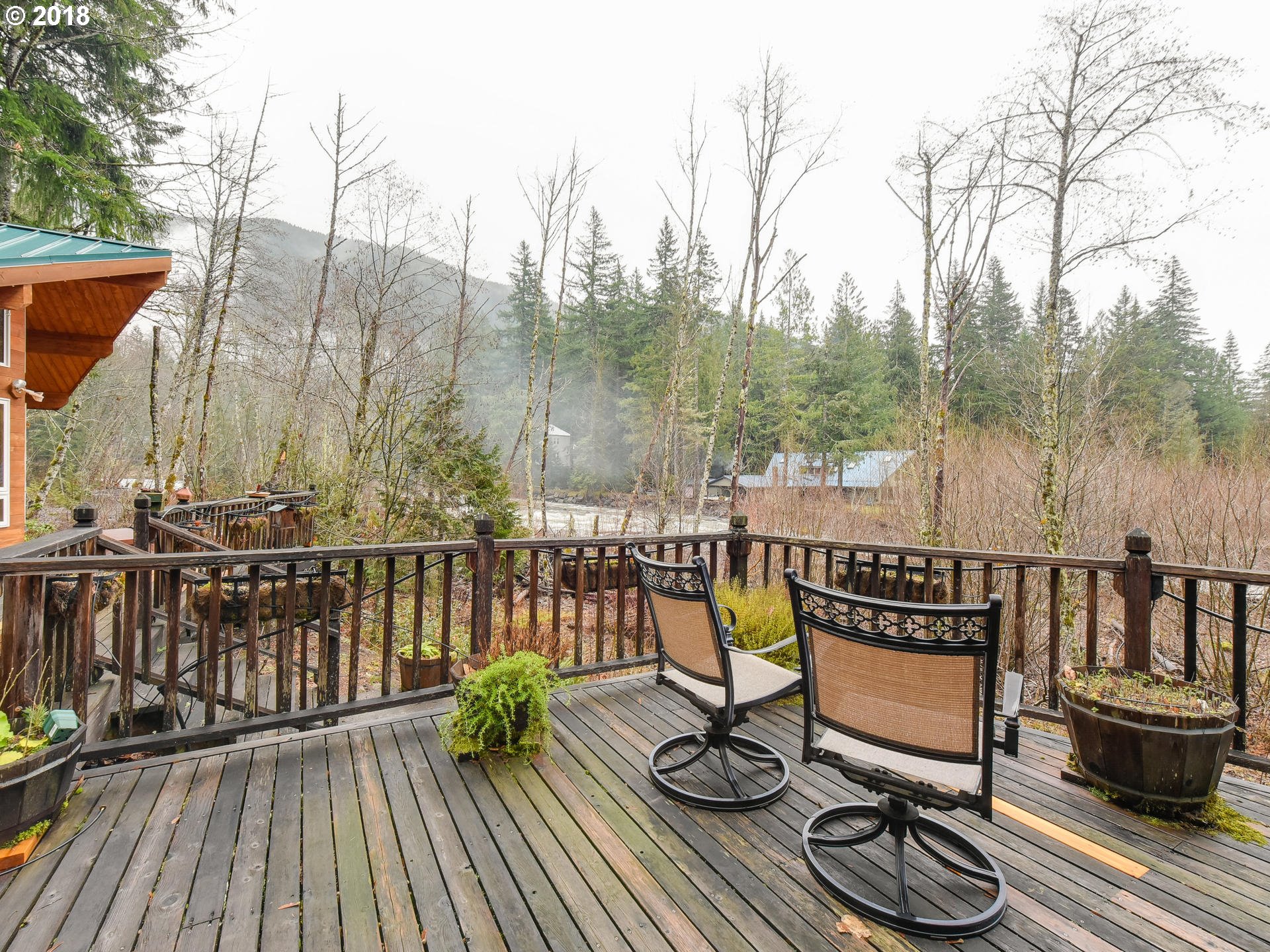 22200 East Lolo Pass Road Rhododendron, OR 97049 - Photo 25 of 32 a view of a balcony with chairs and wooden floor