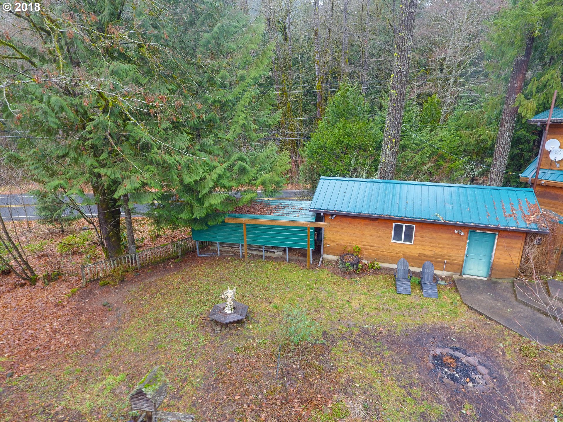 22200 East Lolo Pass Road Rhododendron, OR 97049 - Photo 30 of 32 a view of a backyard with lawn chairs under an umbrella