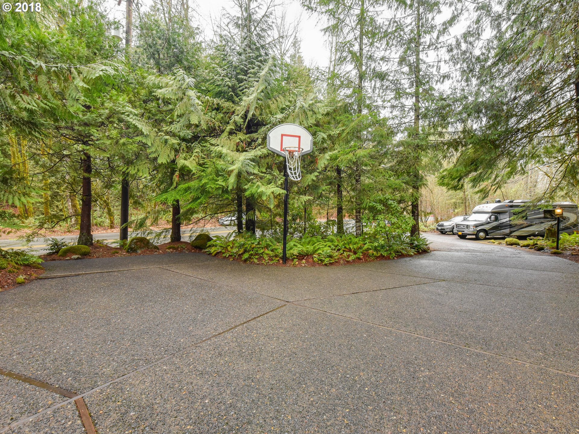 22200 East Lolo Pass Road Rhododendron, OR 97049 - Photo 6 of 32 a backyard of a house with barbeque oven table and chairs