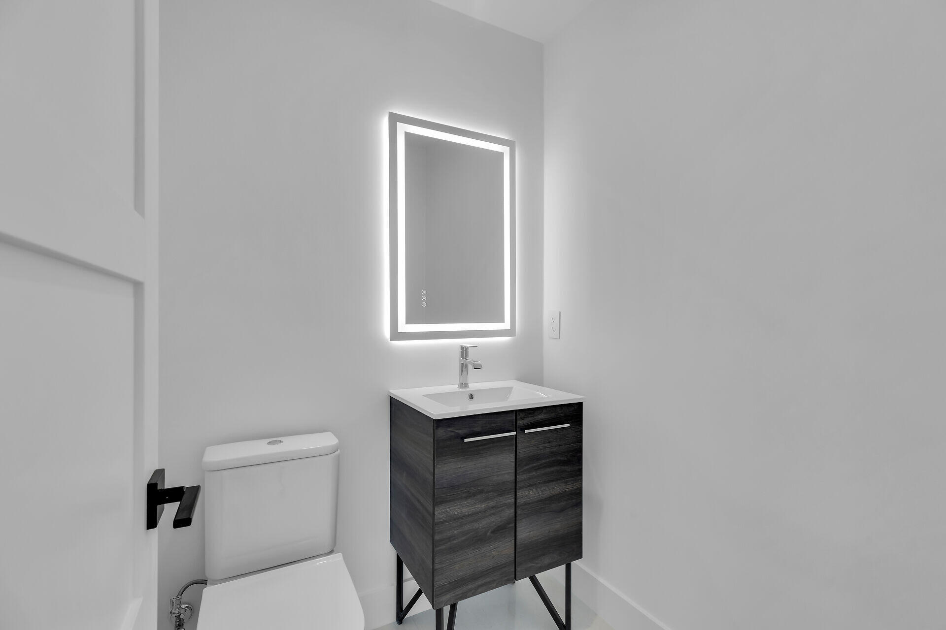 62 Mutiny Place Key Largo, FL 33037 - Photo 30 of 70 a bathroom with a sink a toilet and mirror