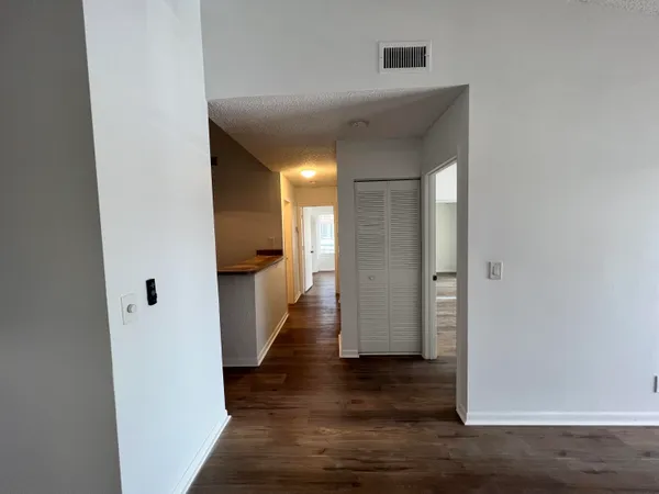 a view of a hallway with wooden floor