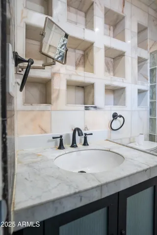 a bathroom with a sink and a mirror