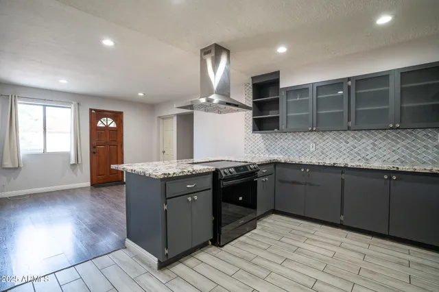 a kitchen with stainless steel appliances granite countertop a sink stove and cabinets