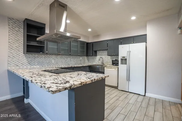 a kitchen with stainless steel appliances granite countertop a sink stove and refrigerator