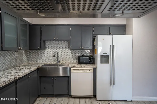 a kitchen with a refrigerator and a sink