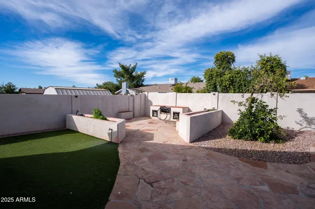 a view of a patio with couches and table and chairs and potted plants