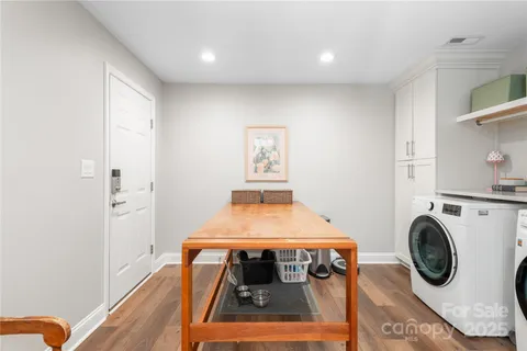 a room with a washing machine and cabinets