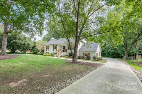 a front view of a house with yard patio and green space