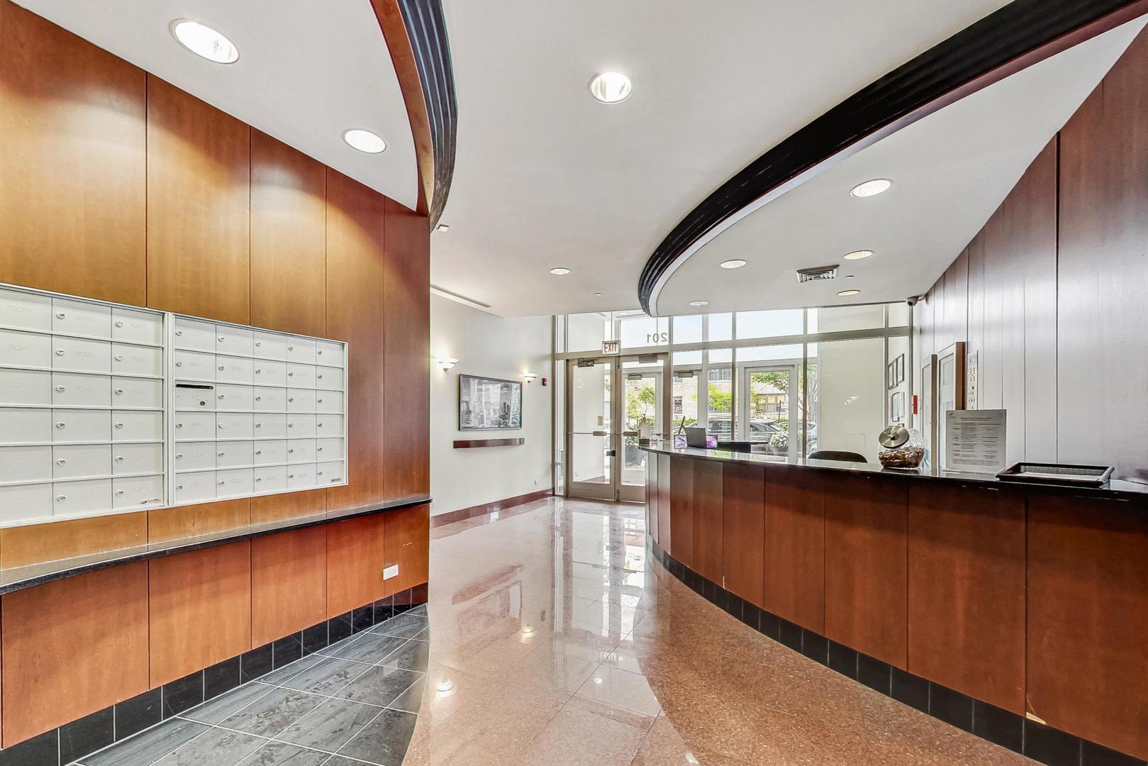 1201 West Adams Street, Unit 609 Chicago, IL 60607 - Photo 17 of 19 a large room with lots of counter space and wooden floor