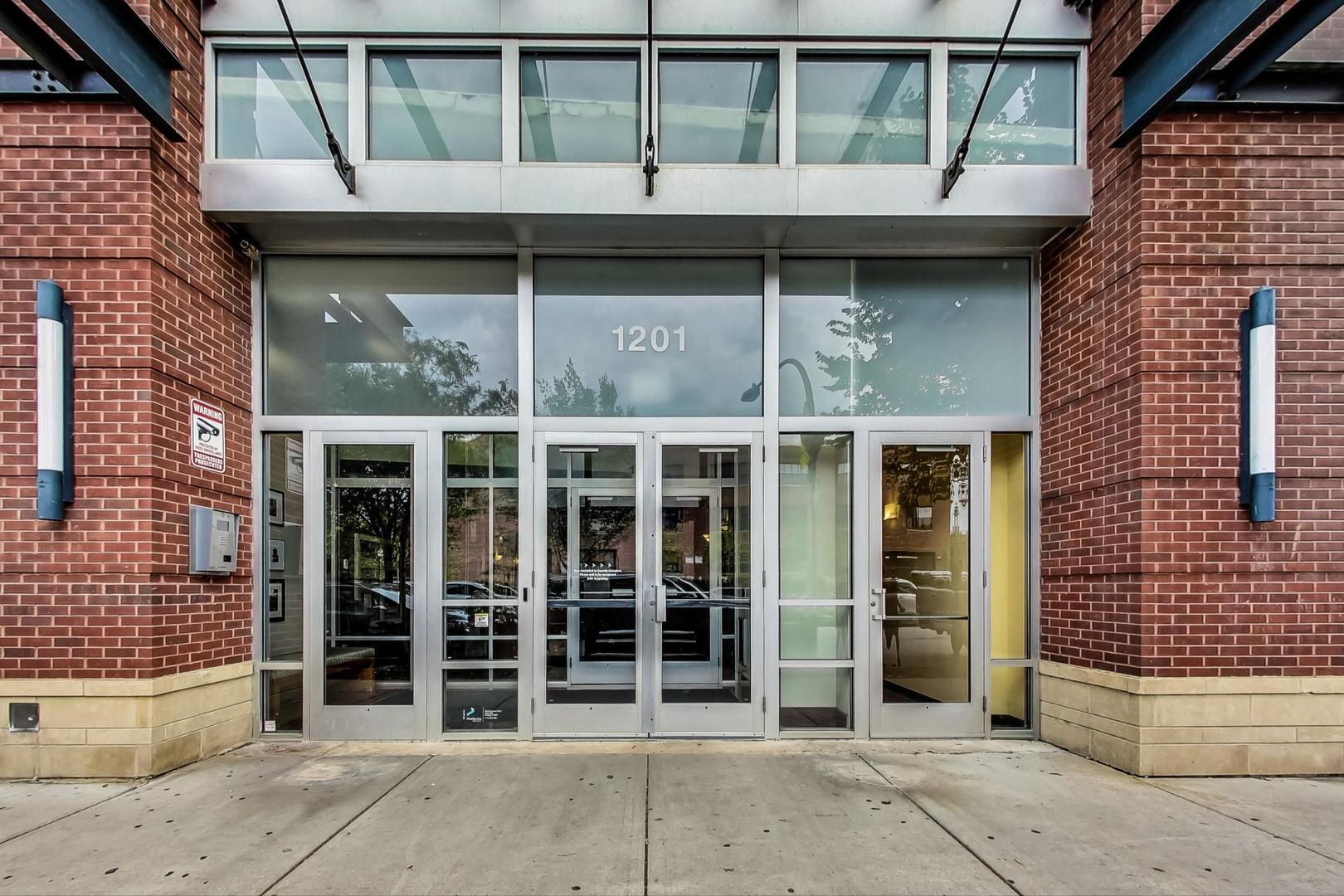 1201 West Adams Street, Unit 609 Chicago, IL 60607 - Photo 2 of 19 a view of a house with a large window and wooden fence