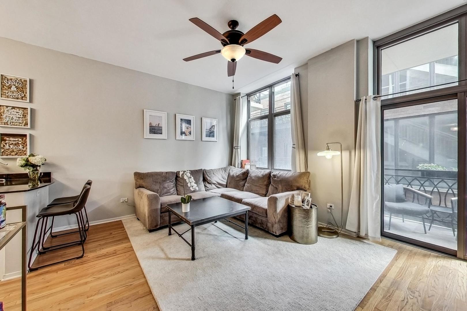 1201 West Adams Street, Unit 609 Chicago, IL 60607 - Photo 4 of 19 a living room with furniture and a window