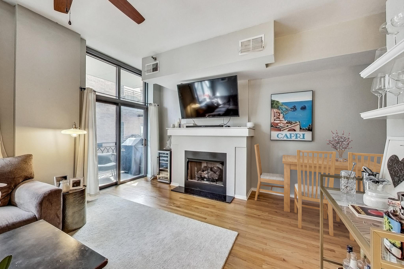 1201 West Adams Street, Unit 609 Chicago, IL 60607 - Photo 6 of 19 a living room with furniture a flat screen tv and a fireplace