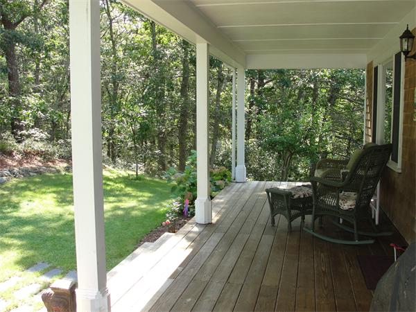1135 Service Road Barnstable, MA 02668 - Photo 8 of 15 a view of a patio with table and chairs and wooden floor