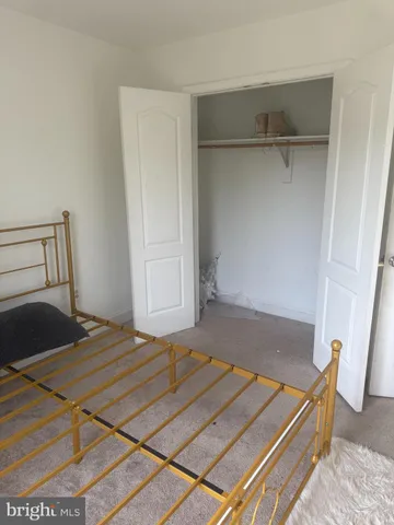 a bedroom with a bed and cabinets