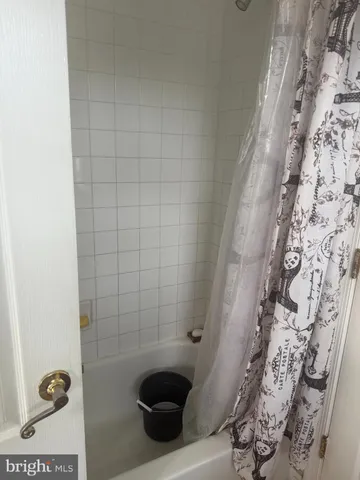 a bathroom with a bathtub and shower
