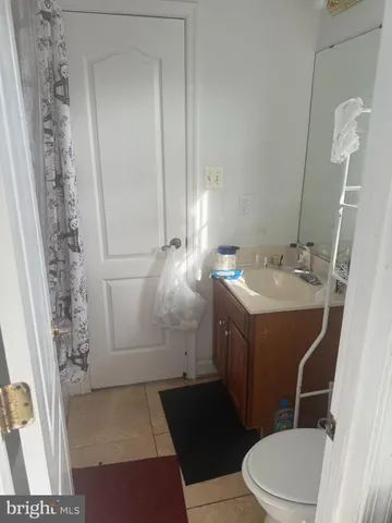 a bathroom with a sink a toilet a mirror and shower