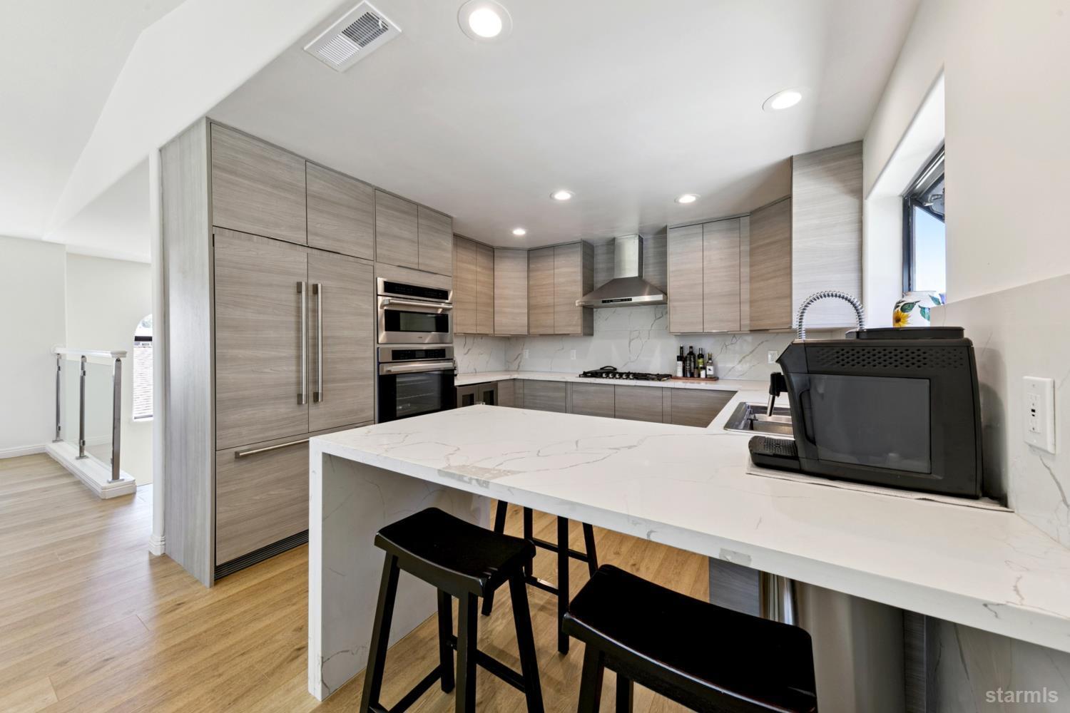 487 Christie Drive South Lake Tahoe, CA 96150 - Photo 25 of 40 a kitchen with stainless steel appliances a microwave sink and refrigerator
