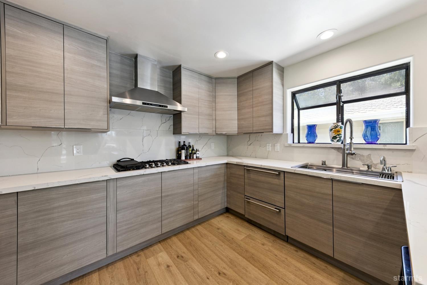 487 Christie Drive South Lake Tahoe, CA 96150 - Photo 27 of 40 a kitchen with stainless steel appliances kitchen island wooden cabinets and a window