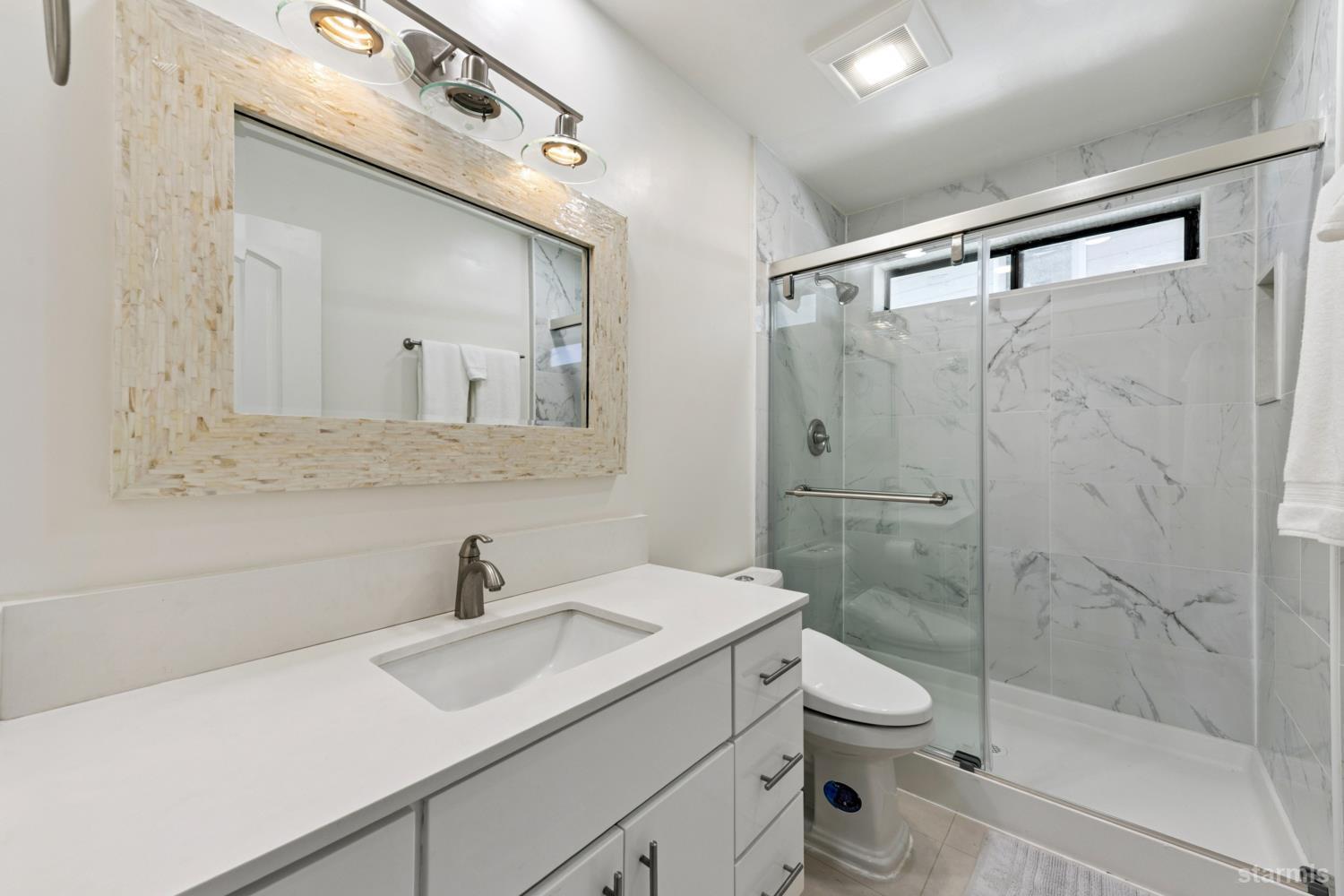 487 Christie Drive South Lake Tahoe, CA 96150 - Photo 37 of 40 a bathroom with a sink toilet a mirror and shower