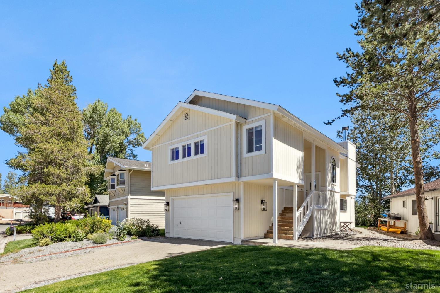 487 Christie Drive South Lake Tahoe, CA 96150 - Photo 6 of 40 a view of a white house with a yard and plants