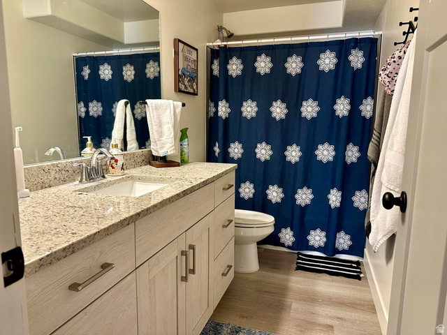 4349 Half Mile Road East Enoch, UT 84721 - Photo 24 of 36 Full bathroom featuring vanity, curtained shower, and light wood-type flooring