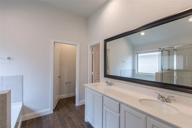 a bathroom with a double vanity sink mirror and