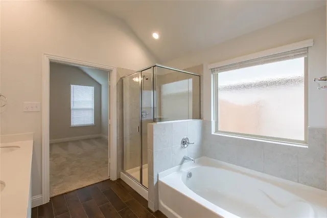 a bathroom with a bathtub and a shower