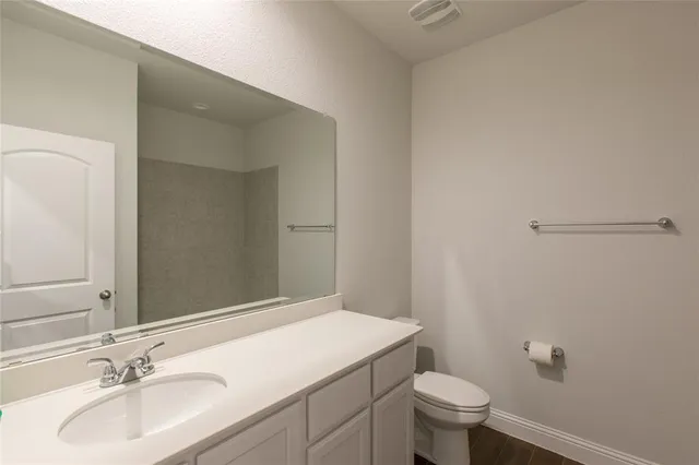 a bathroom with a sink toilet and a mirror