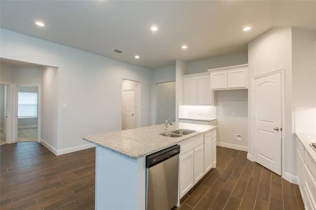 a kitchen with a sink stove and cabinets