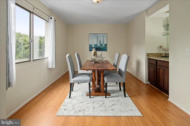 a view of a dining room with a table and chairs