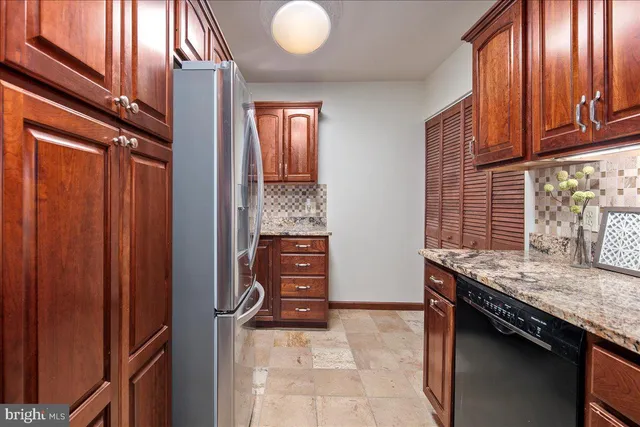 a kitchen with stainless steel appliances granite countertop and refrigerator