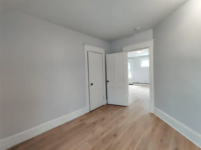 a view of an empty room and wooden floor