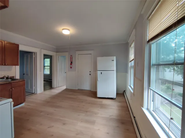 a view of a kitchen with refrigerator and cabinets