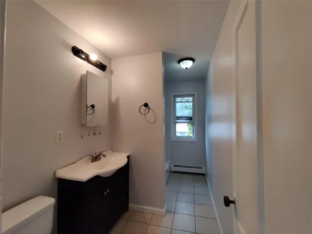 a bathroom with a sink vanity and mirror