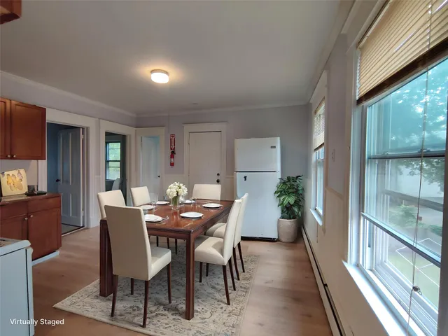 a view of a dining room with furniture window and wooden floor