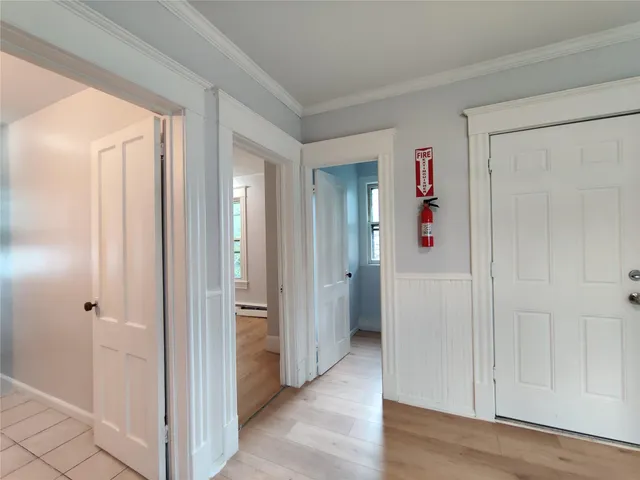 a view of a hallway with wooden floor