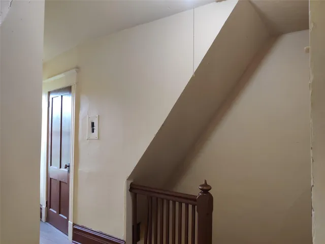 a view of a hallway with wooden floor and entryway