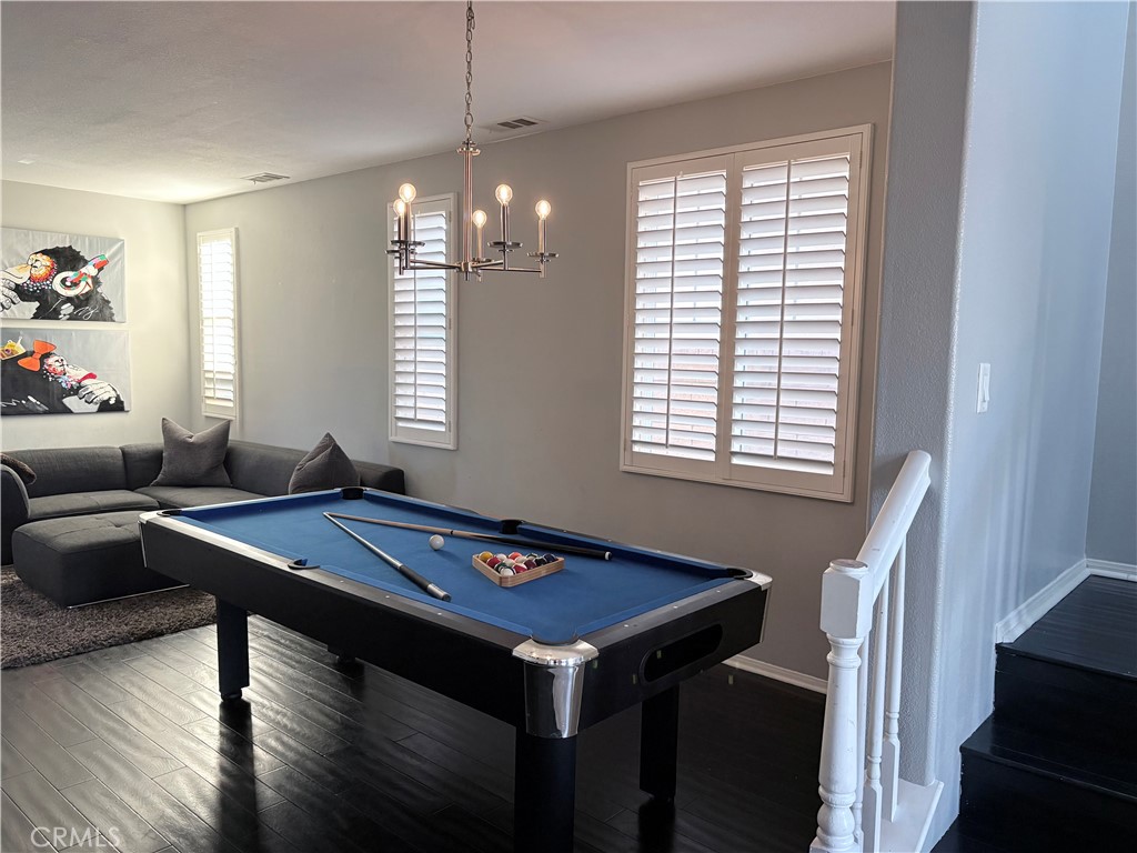 2729 Hornbeam Road Palmdale, CA 93551 - Photo 22 of 35 a dining room with wooden floor furniture and a chandelier