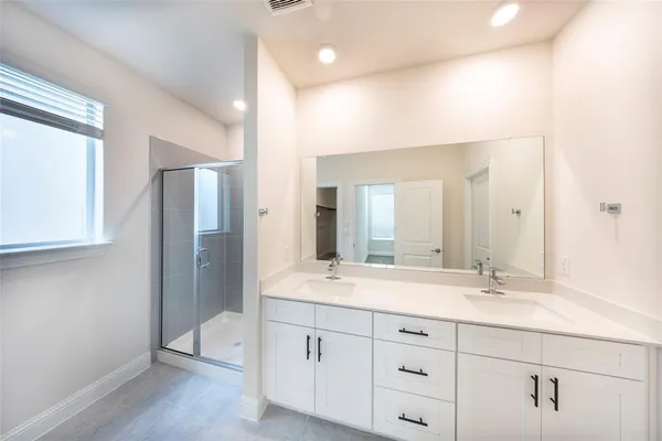 a bathroom with a granite countertop sink mirror and double