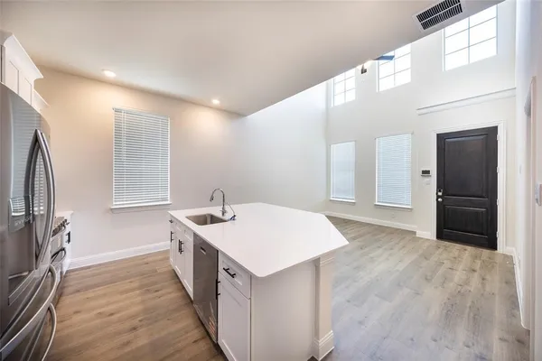 a kitchen with a sink and a refrigerator