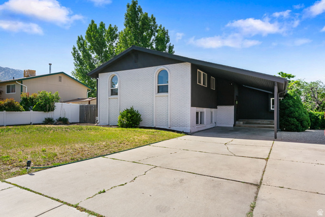 432 Calnette Drive Sandy, UT 84070 - Photo 2 of 48 Split-level exterior featuring white painted brick and dark siding accents